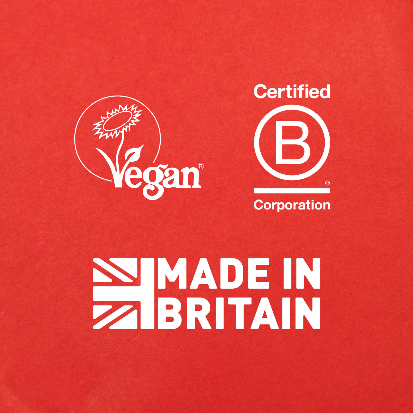 White logos on red—sunflower "Vegan," "Certified B Corporation," and a union jack with "Made in Britain"—are the perfect sign-off for your Pin-up Perm Setting Lotion styled look.
